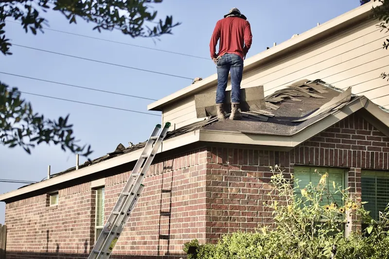 Professional roofer working on a residential roof in Sand Key